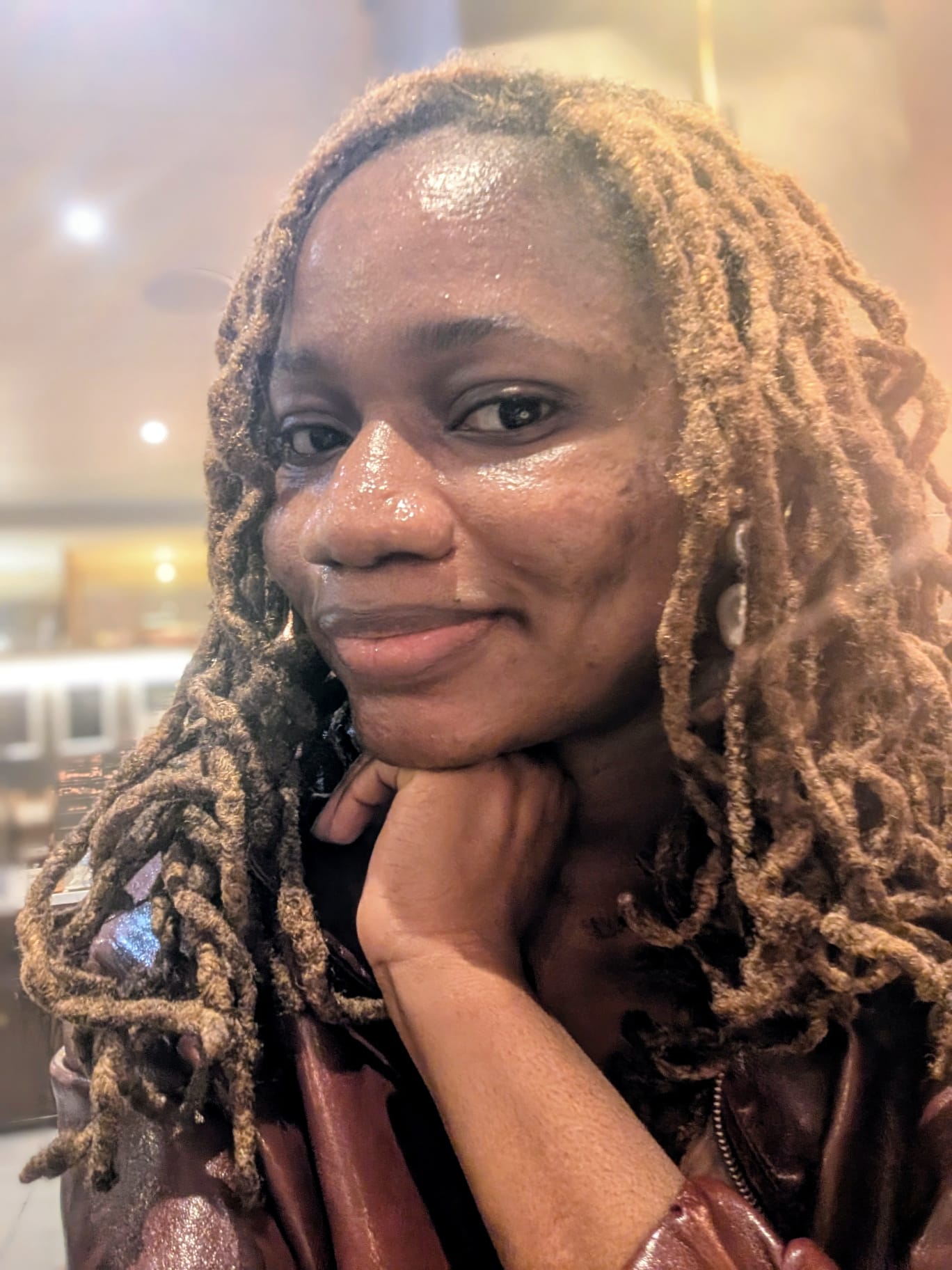 Bola John wearing long loose locs as an everyday loc style