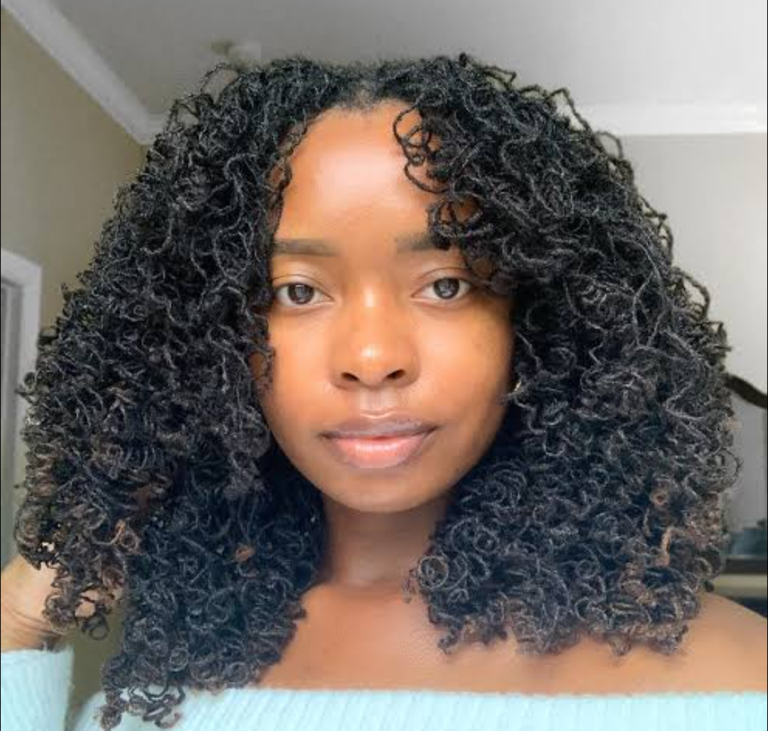Woman wearing a full shoulder-length Sisterlocks hairstyle